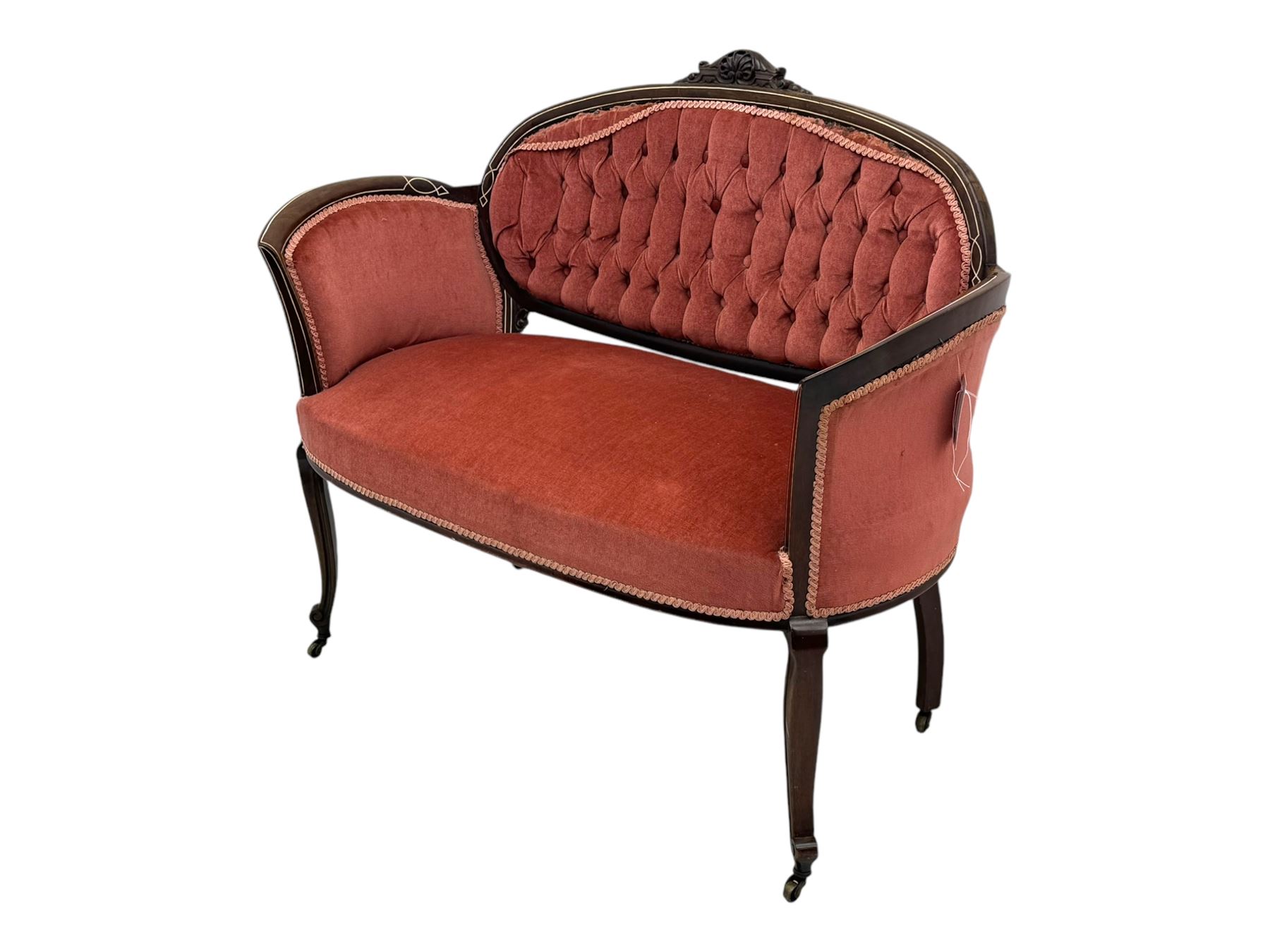 Edwardian inlaid rosewood parlour suite, comprising pair of tub shaped armchairs (W77cm, D69cm, H88cm); and matching two-seat sofa (W112cm, D69cm, H88cm), each with carved crest rails with shell motifs, deep button-tufted oval backs upholstered in pink fabric with braid trim, on cabriole supports