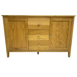 Contemporary light oak sideboard, fitted with three central drawers flanked by two panelled cupboards, on tapering supports