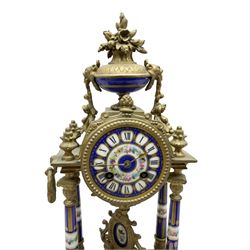 French - late 19th century 8-day spelter portico clock, drum movement raised on four porcelain columns and surmounted by an oval urn, with a conforming dial, cartouche Roman numerals and brass spade hands, twin train Marti countwheel striking movement, striking the hours on a bell. with key. 