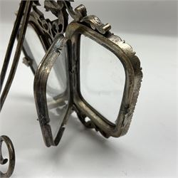 Early 19th century silver plated double photograph frame, each rounded rectangular aperture surrounded by a paste border, with ornate scroll feet and mantling also set with clear paste stones, with easel style support verso, H12cm