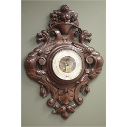  Early 20th century aneroid barometer, carved oak case decorated with fruit above winged beasts and scroll leafage, silvered dial signed 'Van Der Voodt Antwerp', H63cm  