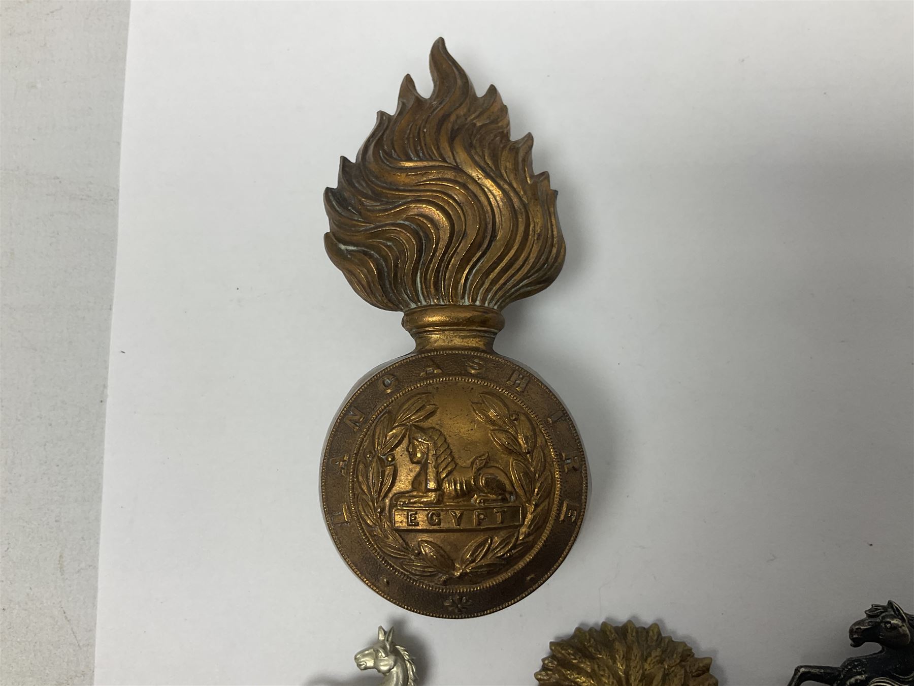 Nineteen Yeomanry metal cap badges including Derbyshire, Northamptonshire, Essex, Glamorgan, Staffordshire, City of London, Surrey, Shropshire, Hertfordshire etc; together with eleven Fusiliers badges including Lancashire, Royal Welch, Northumberland etc (30)