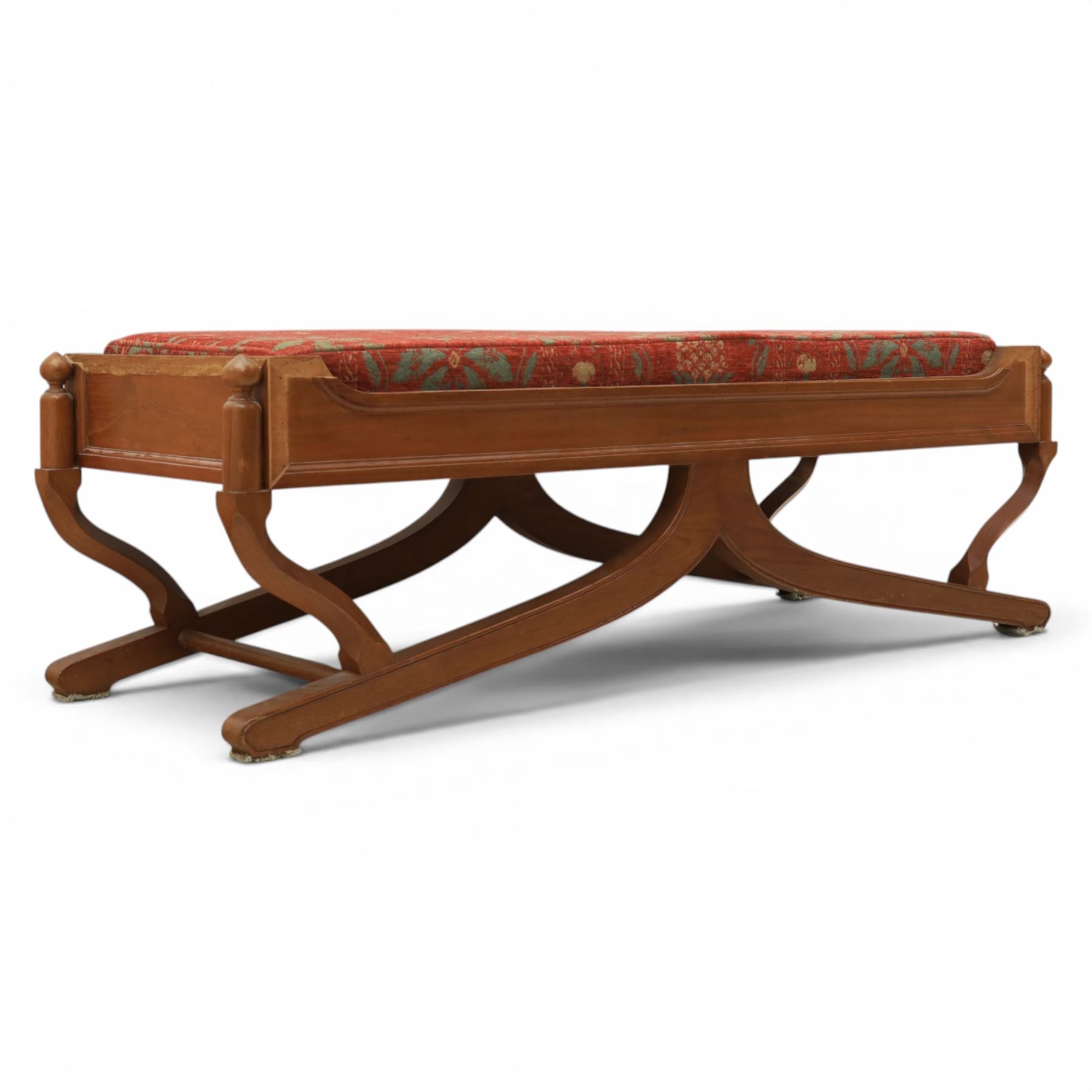 Traditional design teak long foot stool, red patterned seat cushion, on an X-frame base