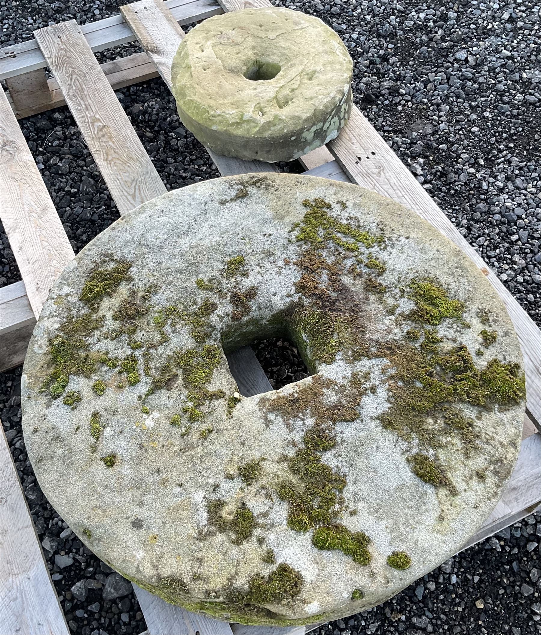 Two 19th century stone mill wheels D64cm and D33cm - THIS LOT IS TO BE COLLECTED BY APPOINTMENT FROM DUGGLEBY STORAGE, GREAT HILL, EASTFIELD, SCARBOROUGH, YO11 3TX