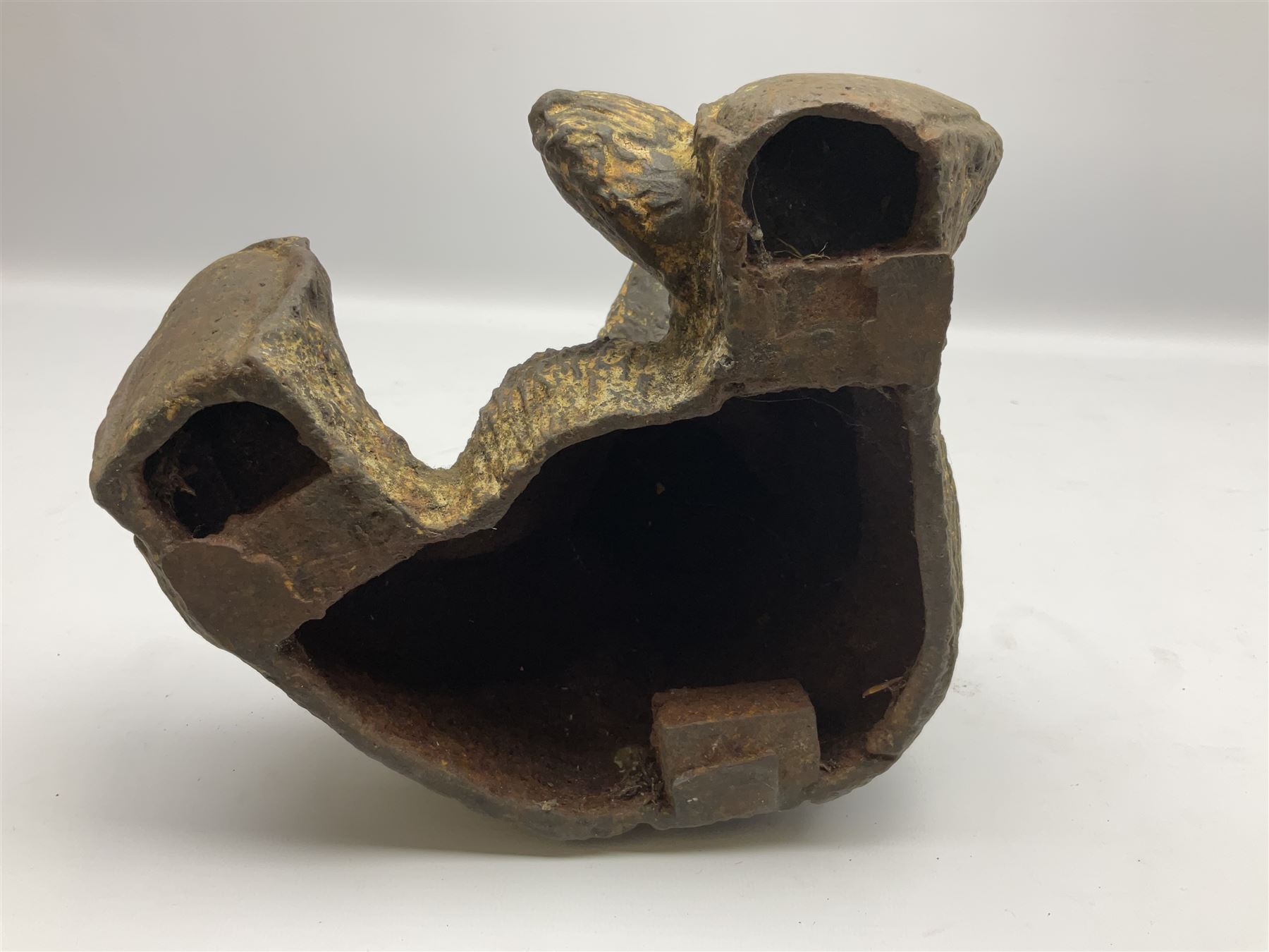 19th century cast iron door stop, modelled as a seated toy bear, with remnants of painted finish, H22.5cm