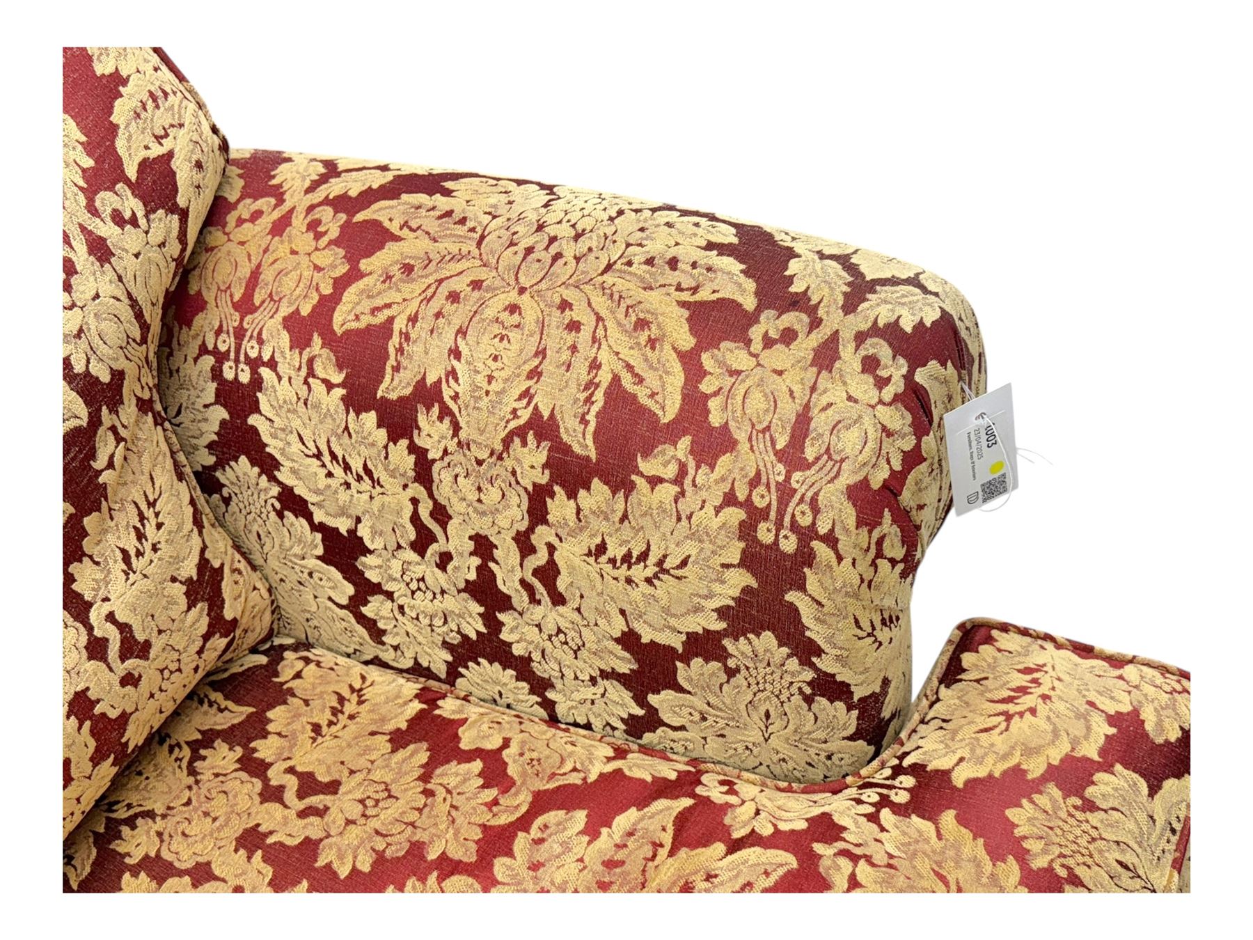 Duresta - pair of Grande three-seat sofas, traditional shaped with rolled arms and upholstered loose cushions, in red ground fabric with raised gold foliate pattern, on turned feet with brass castors 