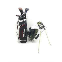 A quantity of TaylorMade golf clubs and others and two bags 