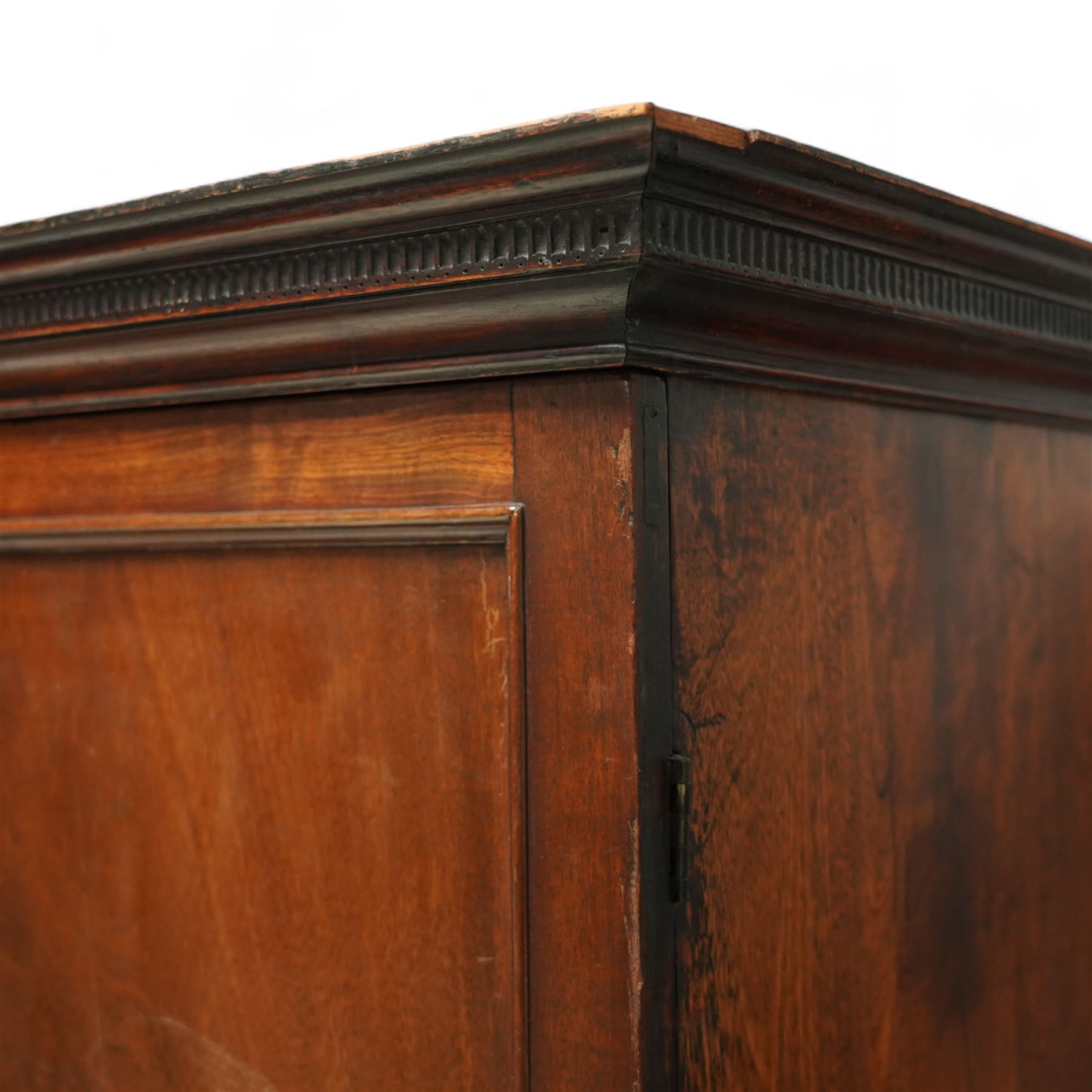 George III mahogany linen press, dentil moulded cornice over a pair of panelled doors enclosing a later fitted interior, lower section with two short over one long cockbeaded drawer, brass swan neck handles, shaped bracket feet