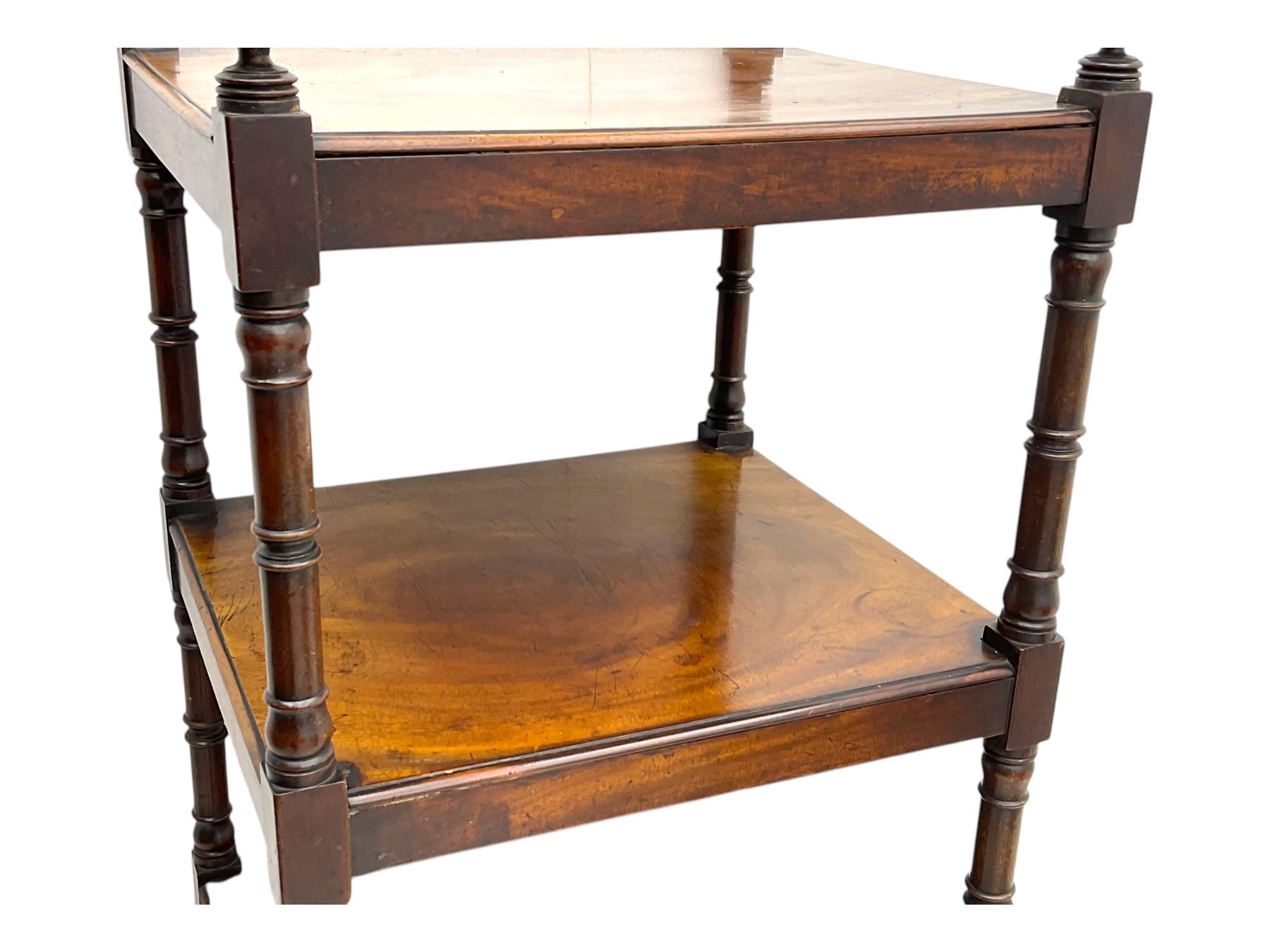 Early 19th century mahogany whatnot, with four rectangular shelves, the lower shelf fitted with a single drawer, supported by slender turned columns, raised on turned supports with brass castors