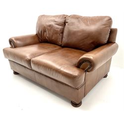 Three seat studded tan leather sofa, scrolling arms, turned supports (W190cm) with matching two seat (W155cm) armchair (W100cm) and footstool 