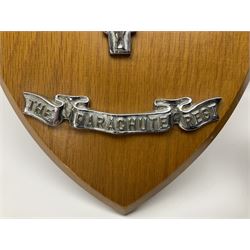 Parachute regiment - chrome crest on oak easel shield; three cloth badges; small silver plated figure; and pin badge; together with 10cm diameter cannon ball etc