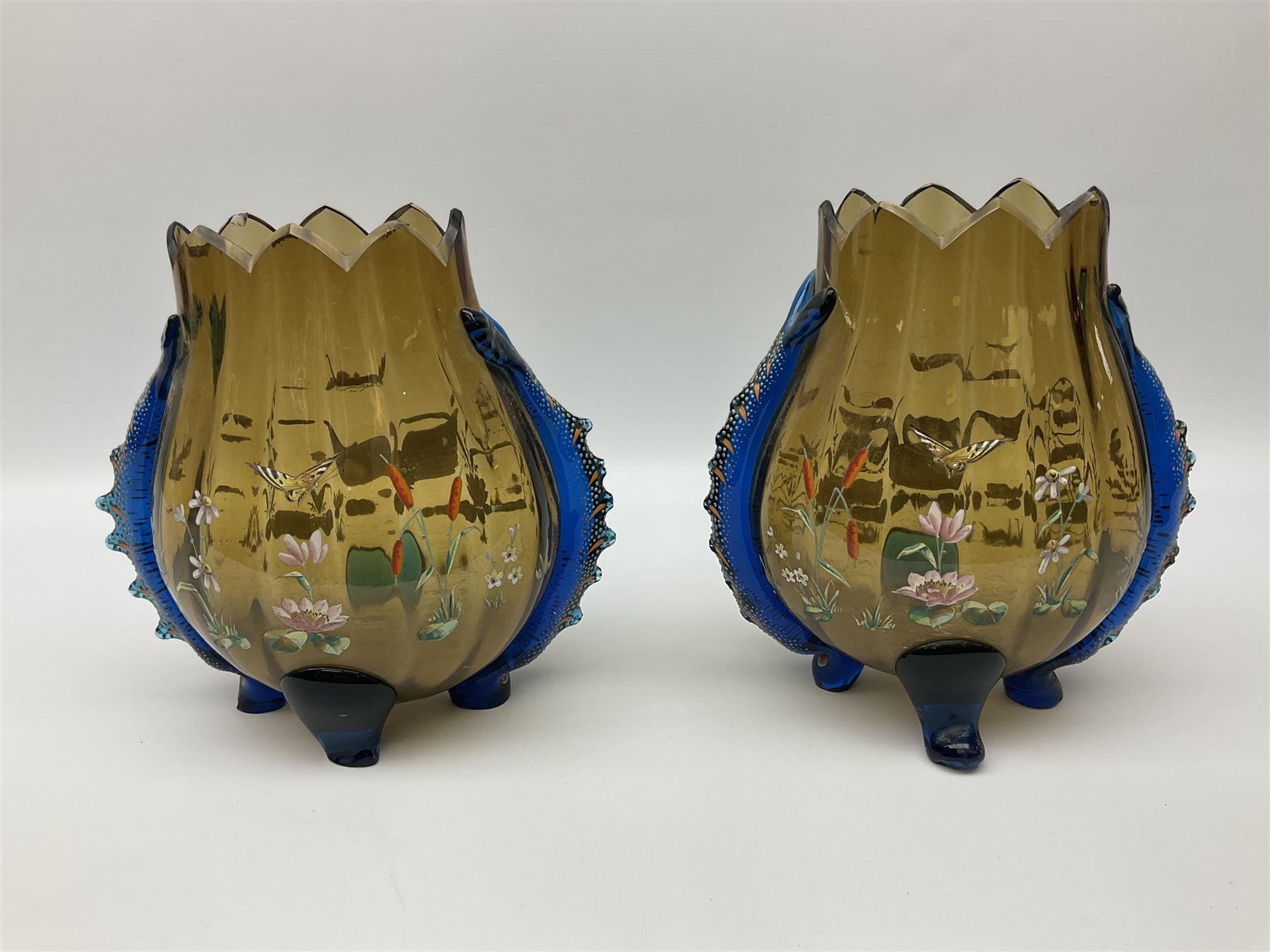 Pair of 19th century glass vases in the style of Auguste Jean, of bulbous form with lobed rim and applied blue glass zoomorphic handles, painted with enamel flowers, dragonflies and swans, upon four blue glass feet, H26cm