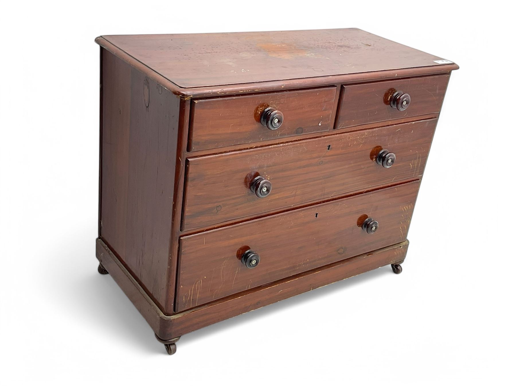 Victorian 19th century stained pine chest of drawers, rectangular top above two short and three long drawers with turned wooden handles, raised on bun feet with castors.