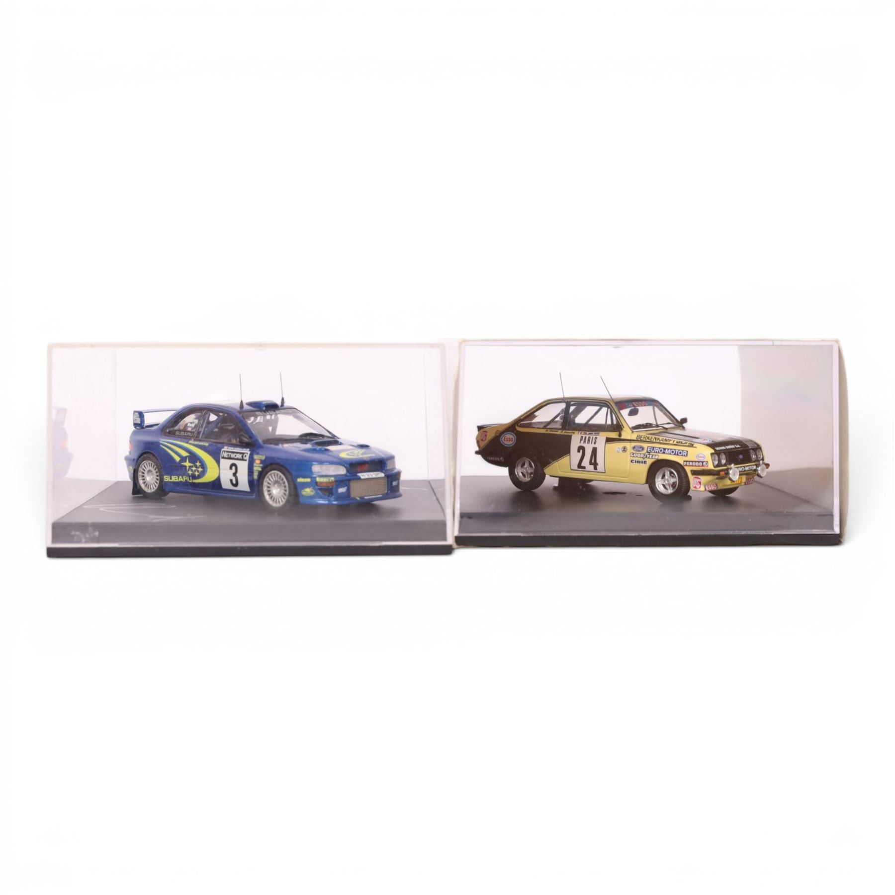 Four Troufeu 1:43 scale diecast model rally cars, including two limited edition Subaru's commemorating wins by Richard Burns, a Ford Escort RD 2000 and a Ford Escort Mk II, all in acrylic display cases