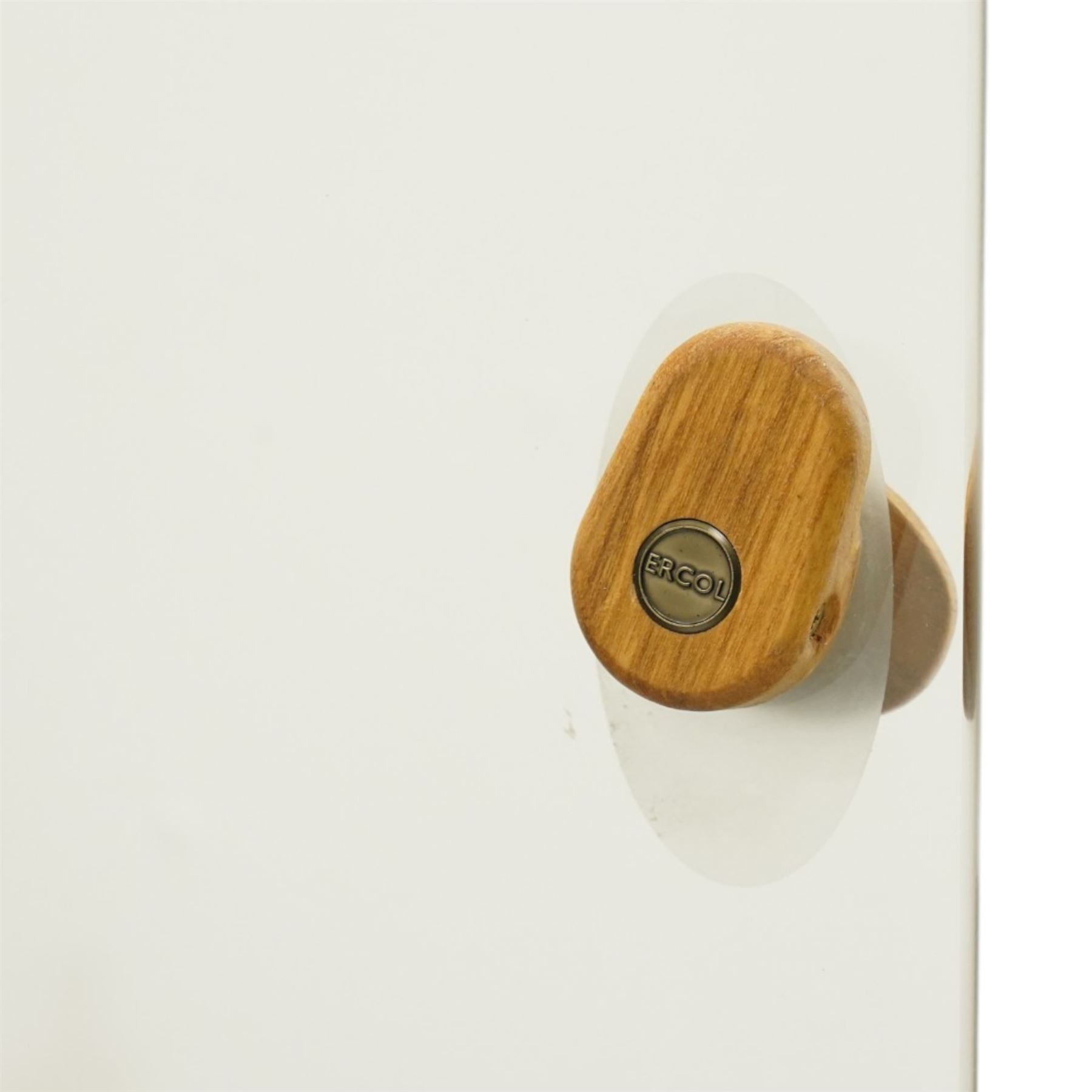 Ercol - elm corner display cabinet, Model 3856. Glazed upper section with glass door enclosing two glass shelves and interior light, above panel cupboard door, with rounded uprights and circular turned handles, on plinth base