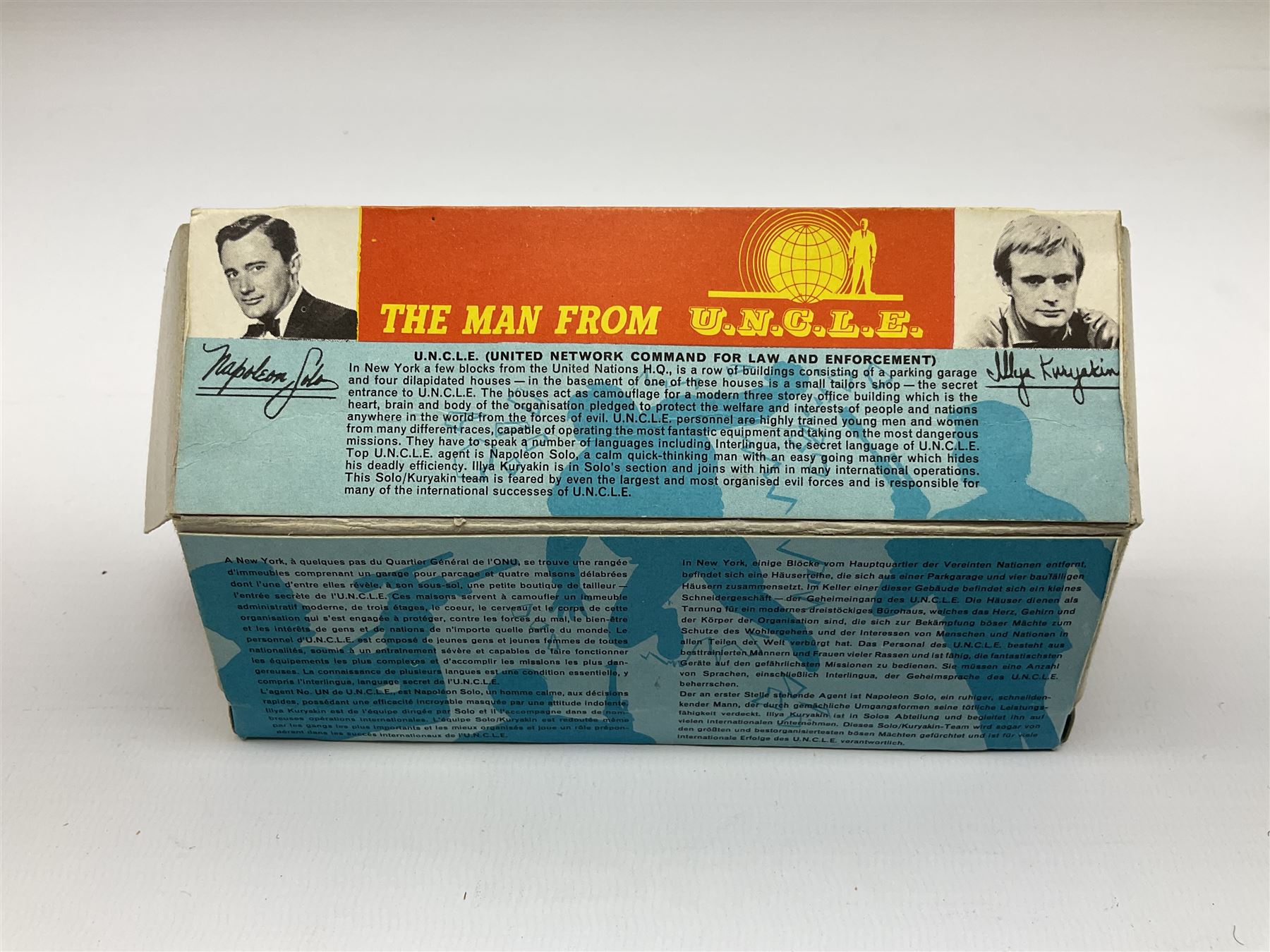 Corgi Toys - 'The Man from UNCLE' Thrushbuster No.497, in blue with cast hubs, plastic lights, complete with plastic figures, inner pictorial stand with circular cardboard packing piece, yellow card protective packing disc and '3-D Waverley Ring'; boxed