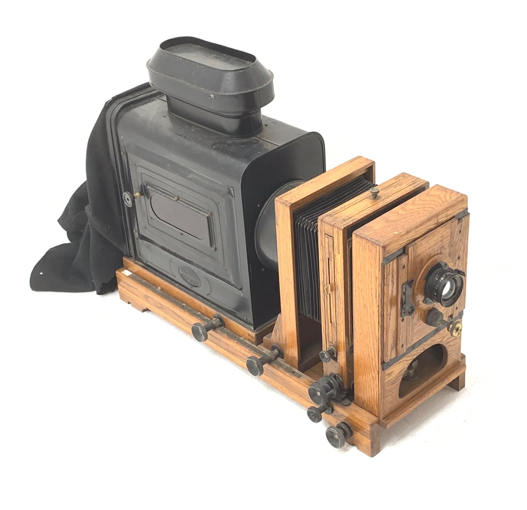  Very large oak and brass magic lantern style enlarger, the black japanned lamp housing with embossed Ernemann Dresden plaque, rack and pinion focusing, two folding bellows, rise-and-fall and pivoting facilities and Ross London 5