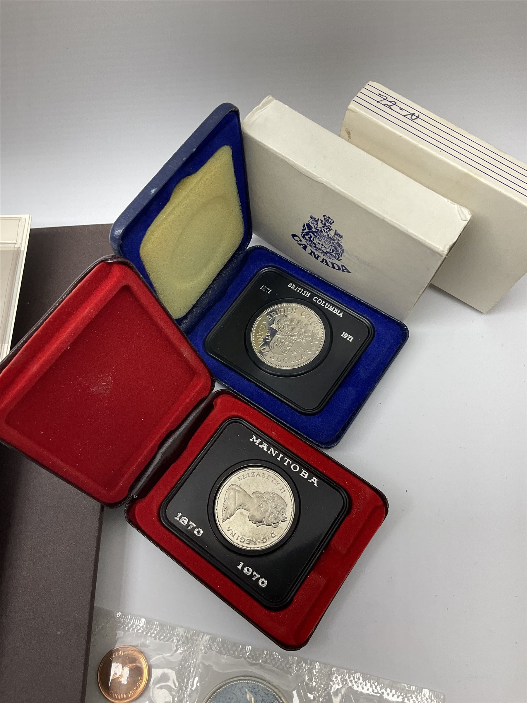 Mostly Canadian coins including 1967 six coin set, various Canadian 50 cent coins, various nickels, Royal Canadian Mint 1990 specimen coin set in blue folder with outer sleeve, various Canadian dollars etc, in folders and loose