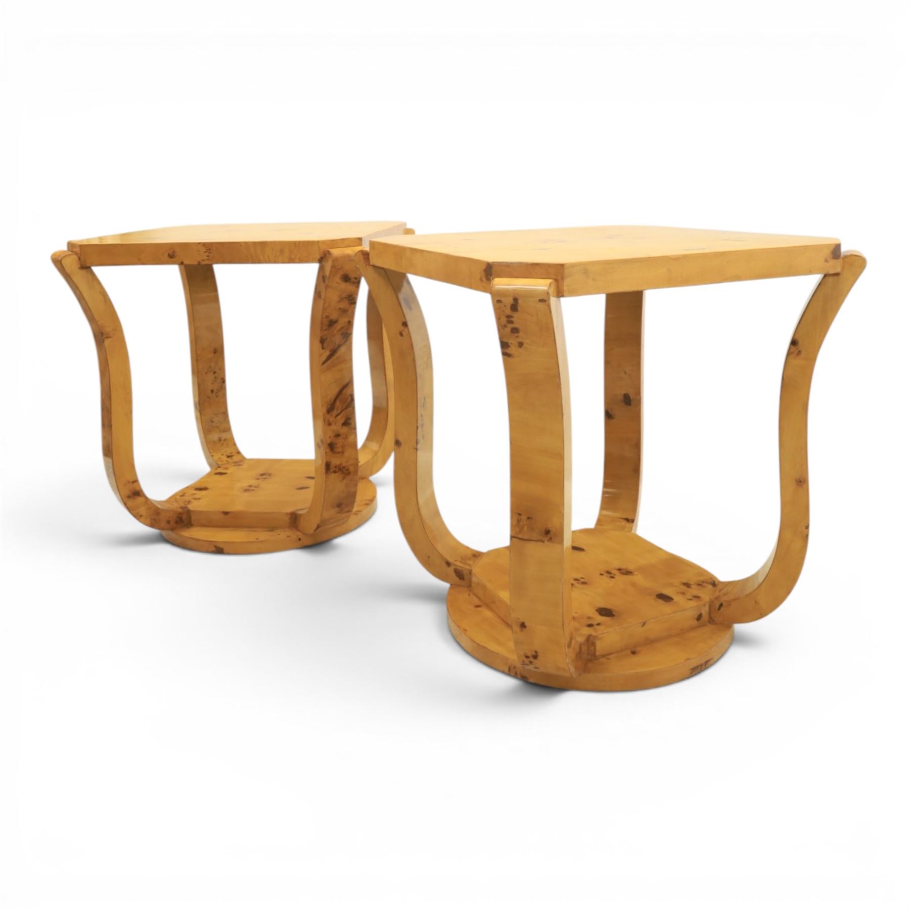 Art Deco style pair of burr walnut lamp tables, octagonal top with rounded corners and book-matched veneers, on four shaped supports united by a circular undertier and plinth base