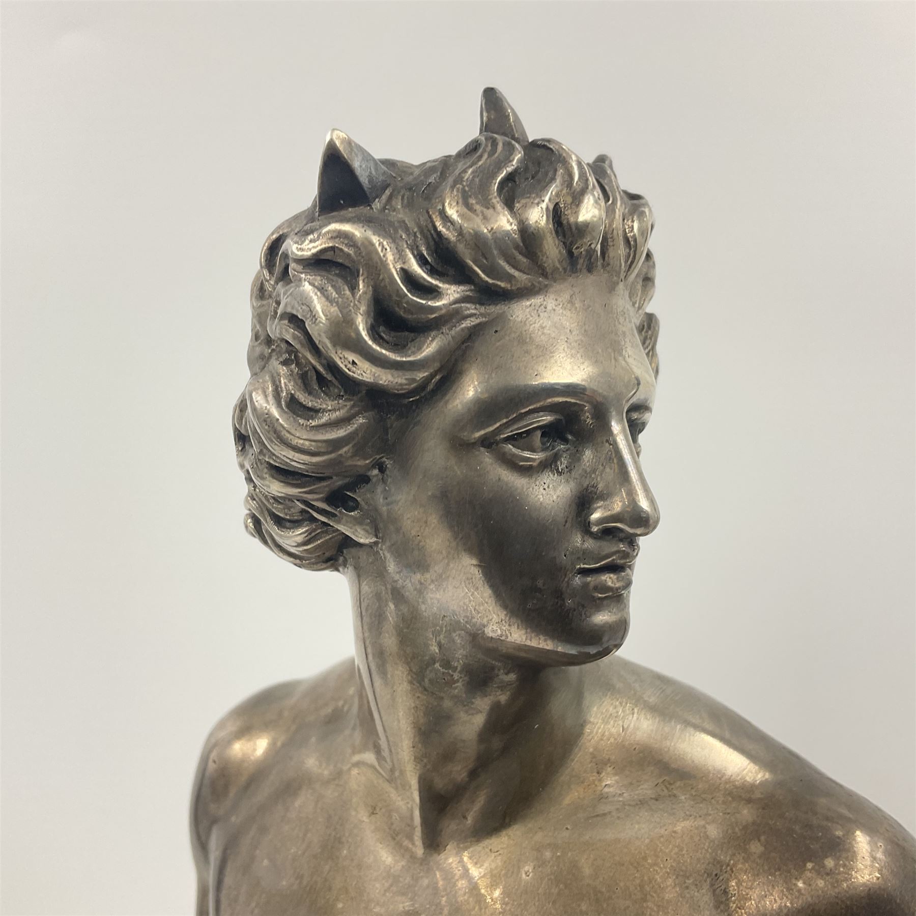 20th century silver plated figure, modelled as a classical male figure, possibly Prometheus, holding flames, one foot resting atop a small dragon, upon a circular spreading base, overall H37.5cm