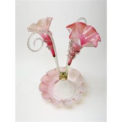 A Victorian cranberry and Vaseline glass epergne, the frilled bowl supporting two frilled trumpets and two canes, H41cm. 