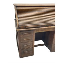 Early 20th century oak twin pedestal desk, tambour roll top enclosing fitted interior, fitted with two slides and seven drawers