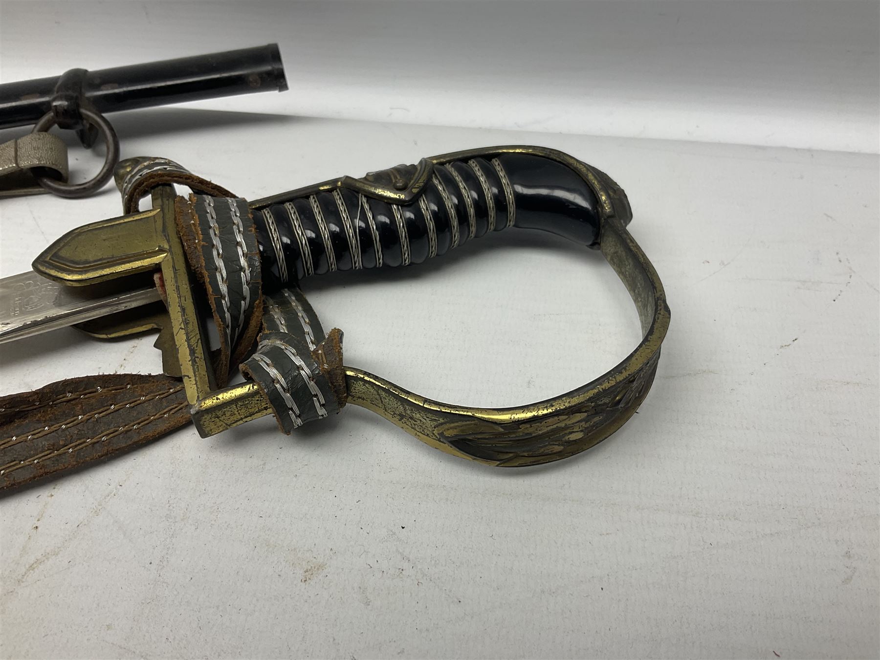 WW2 German Army Prinz Eugen Pattern Officers Dress Sword by Carl Eickhorn, the 80.5cm slightly curving fullered blade with makers name to the ricasso, gilt brass hilt with eagle to the cross-piece and relief of oakleaves to the ferrule, Prinz Eugen style down winged eagle to the pommel of the backstrap; grip retains the original wire binding; in original black painted scabbard with single hanging ring, leather hanger marked 'RZM M5/71 OLC' and silvered knot L97cm overall