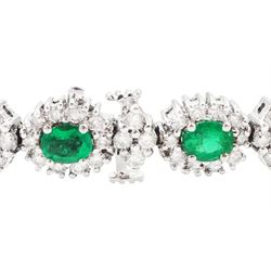 18ct white gold emerald and diamond bracelet, fifteen oval cut emeralds, each surrounded by ten round brilliant cut diamonds and spaced by a further four diamonds, stamped, total emerald weight approx 3.30 carat, total diamond weight approx 2.10 carat
