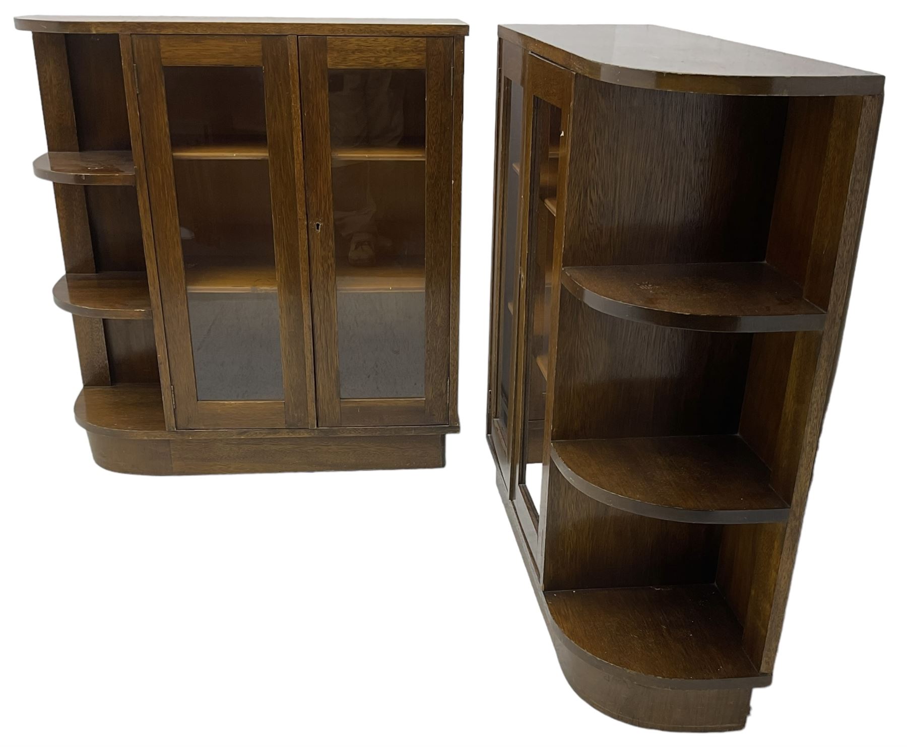 Pair of mid-20th century oak bookcases, rectangular form with curved ends, enclosed by glazed doors and fitted with shelves