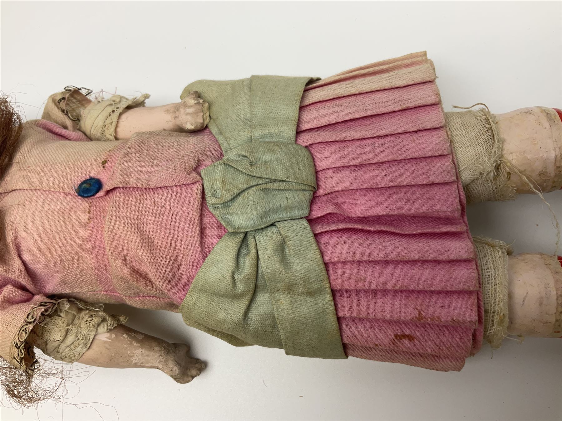 Victorian wax shoulder head doll with applied hair, inset glass eyes and jointed body with composition lower limbs; faded pink dress H35cm