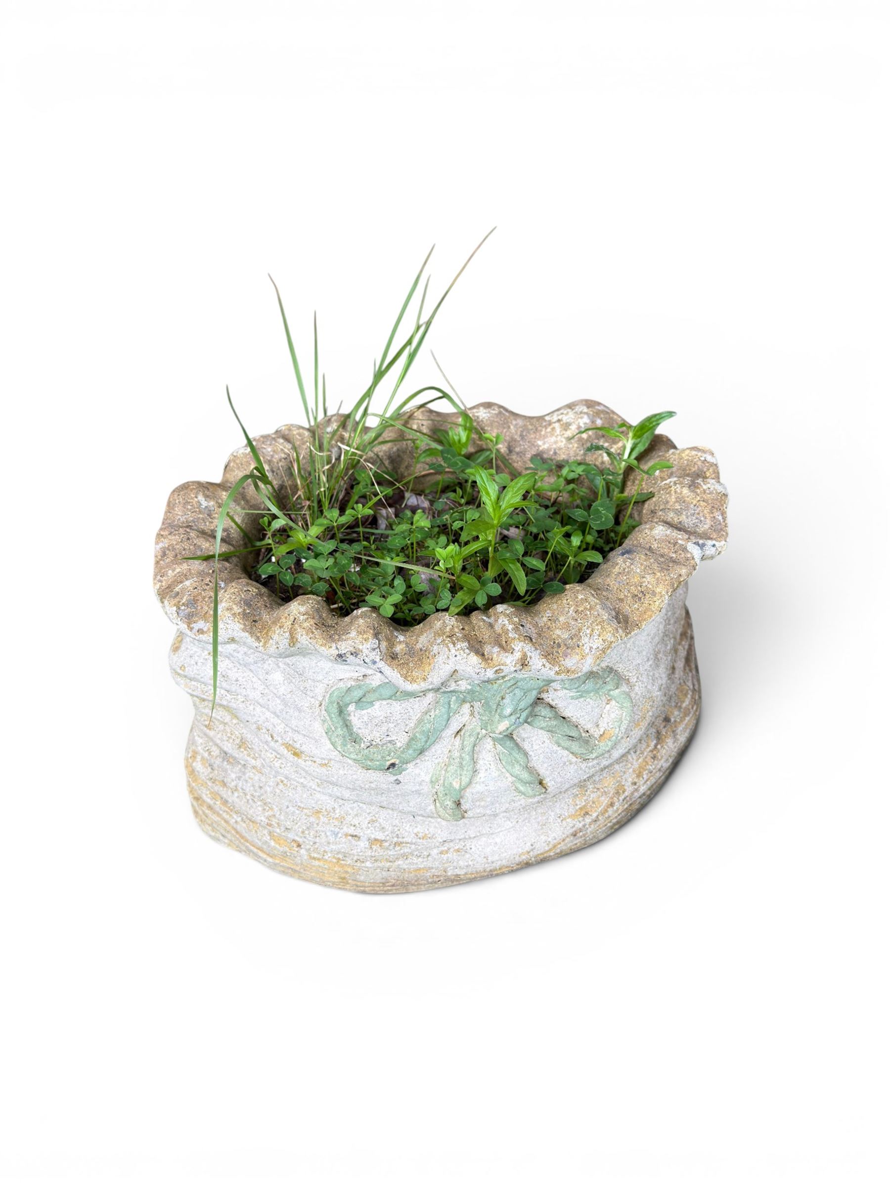 Four cast stone garden planters in the form of ribbon tied planting sacks