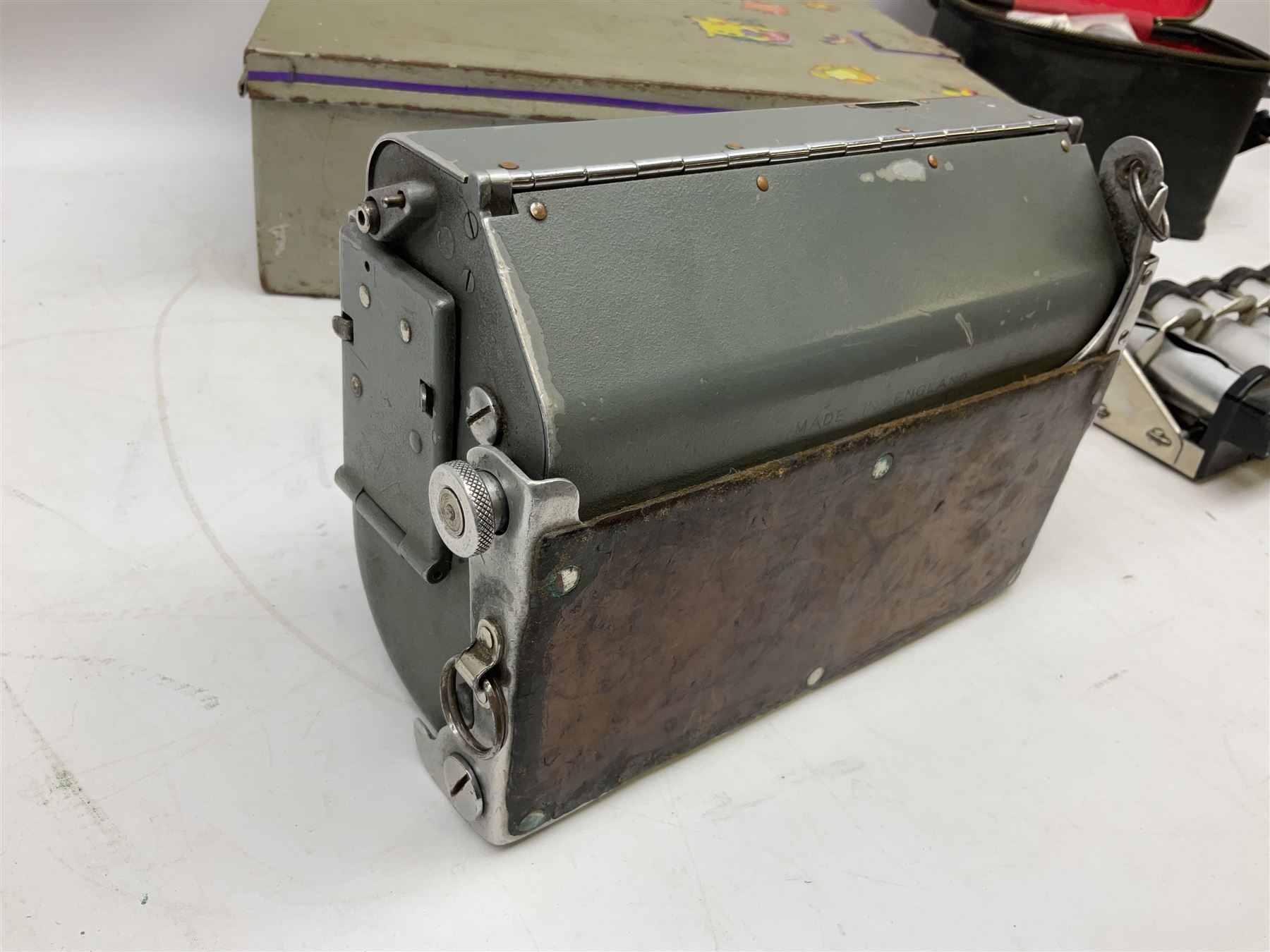 Bell Punch Company of London 'The Ultimate' five lever fare collection machine, together with an Almex ticket machine with shoulder strap, two brass Halifax transport cap badges, other chrome tramway cap badges, etc