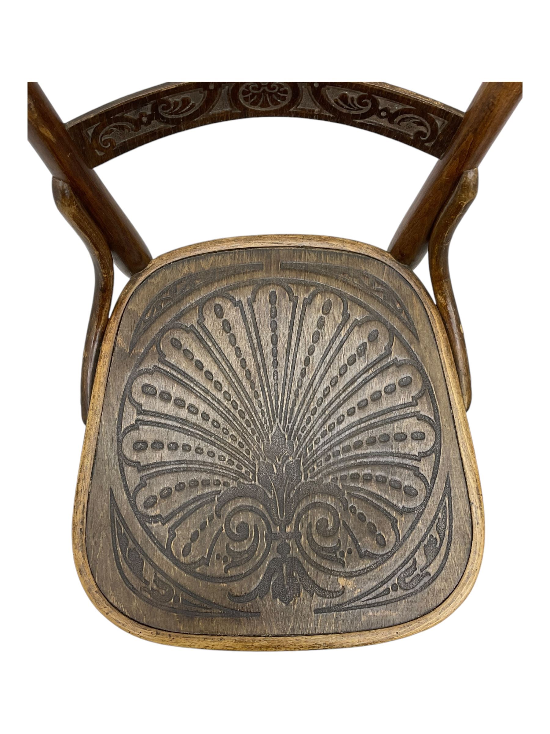 Jacob & Josef Kohn - set of four early 20th century Austrian bentwood chairs, each with carved decoration to the shaped backrest and shaped seat, on splayed supports with stretchers, marked with the manufacturer's stamp and paper label beneath