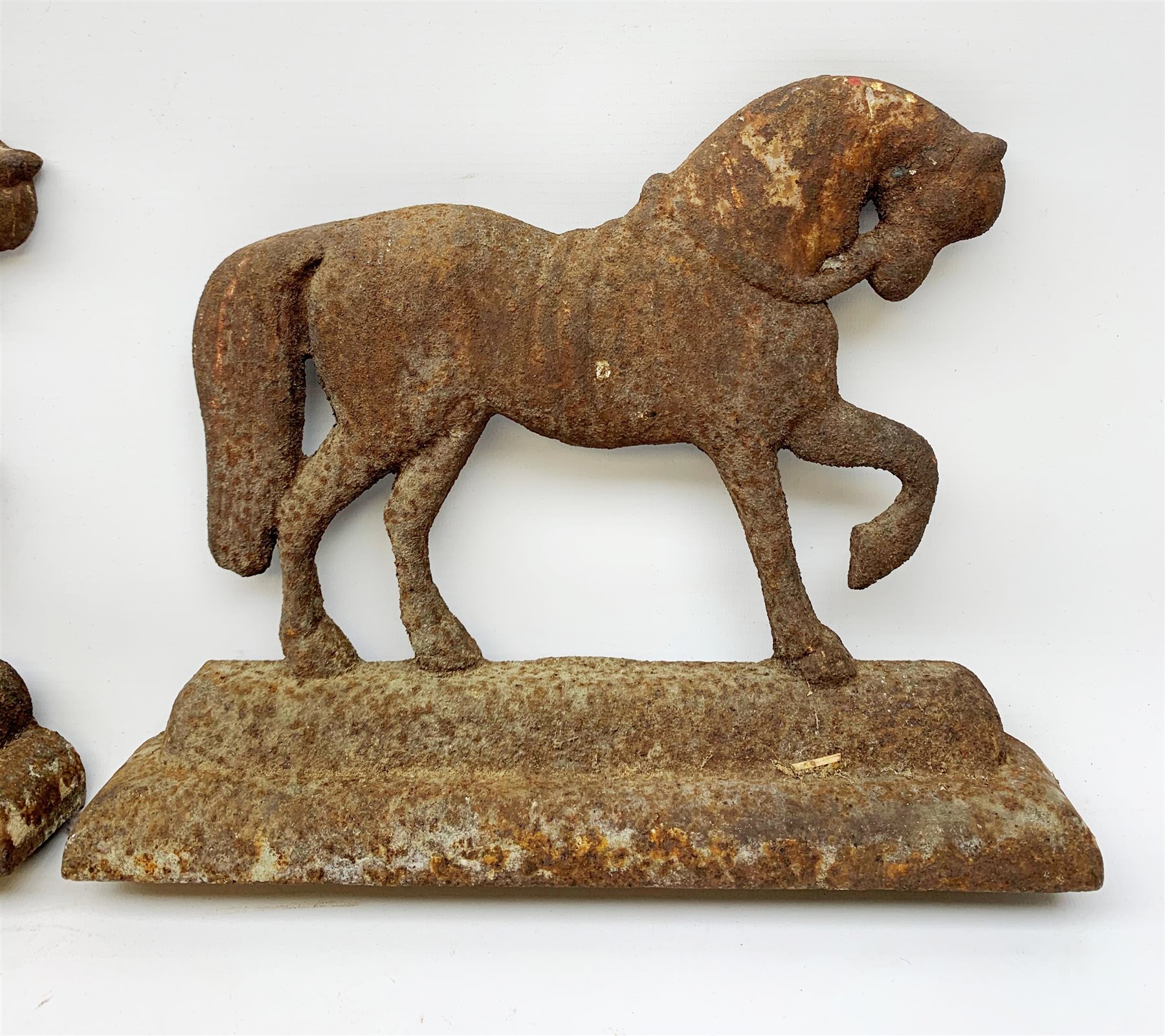A pair of cast iron door stops, each modelled as a horse, H24cm L30cm