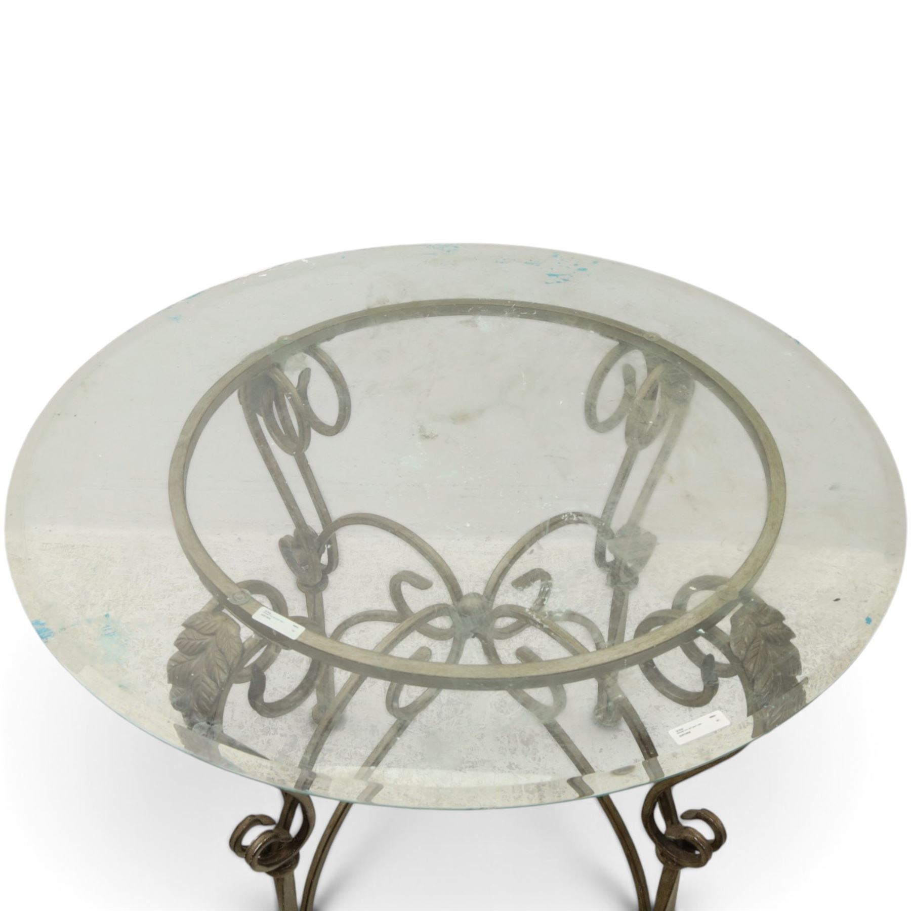 Wrought metal and glass table, with silvered foliate and scrolled design