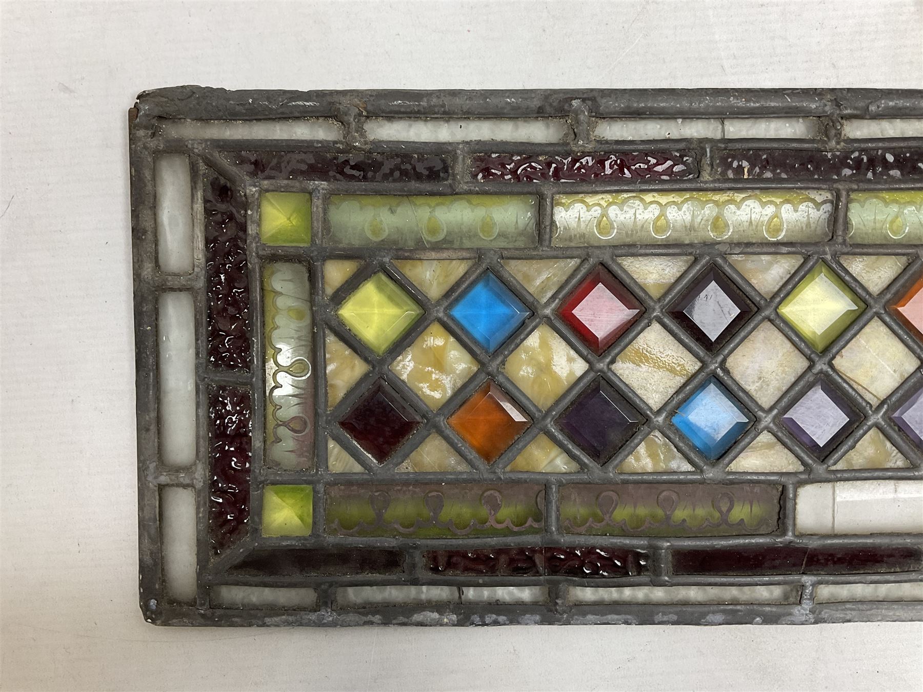Stained glass and leaded rectangular window panel, with a Dimond pattern to the centre, H56cm, L22cm 