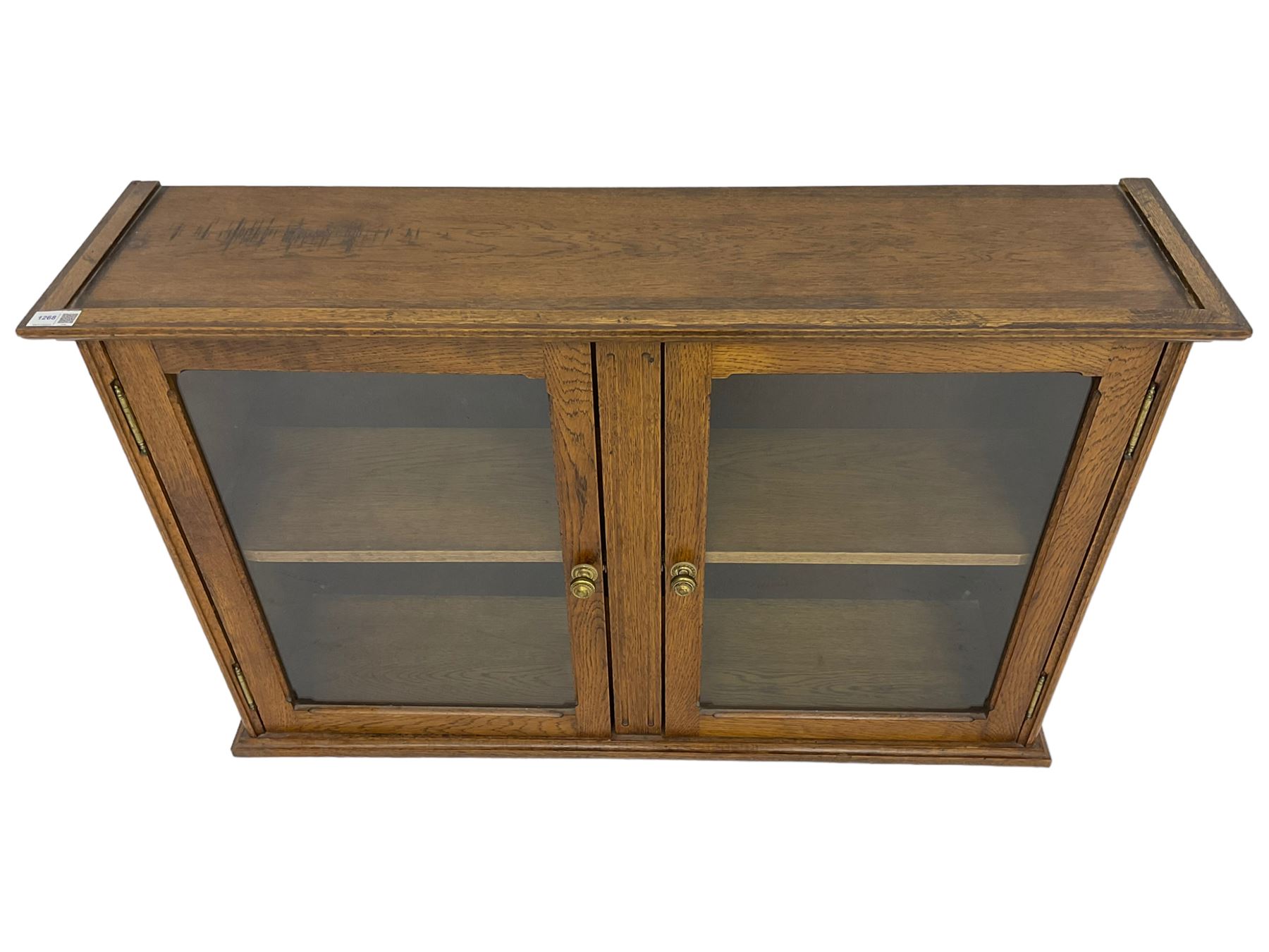 20th century low oak and glazed bookcase, double cupboard enclosing two shelves