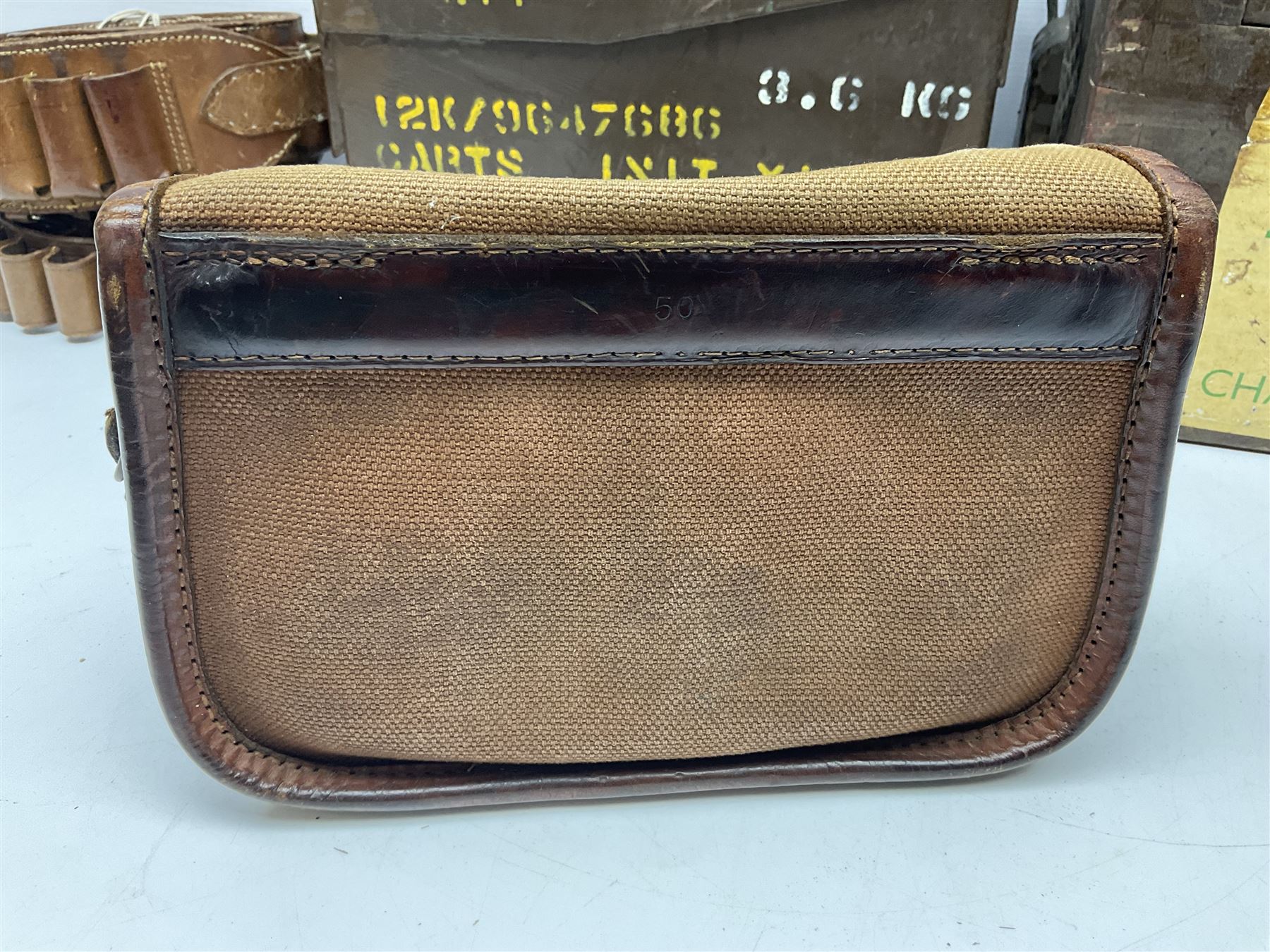 Miscellaneous shooting accessories - W.J. Bowman & Sons clay pigeon launcher; two leather cartridge belts; three cartridge bags; two canvas/leather game bags; and two metal/wooden cartridge boxes