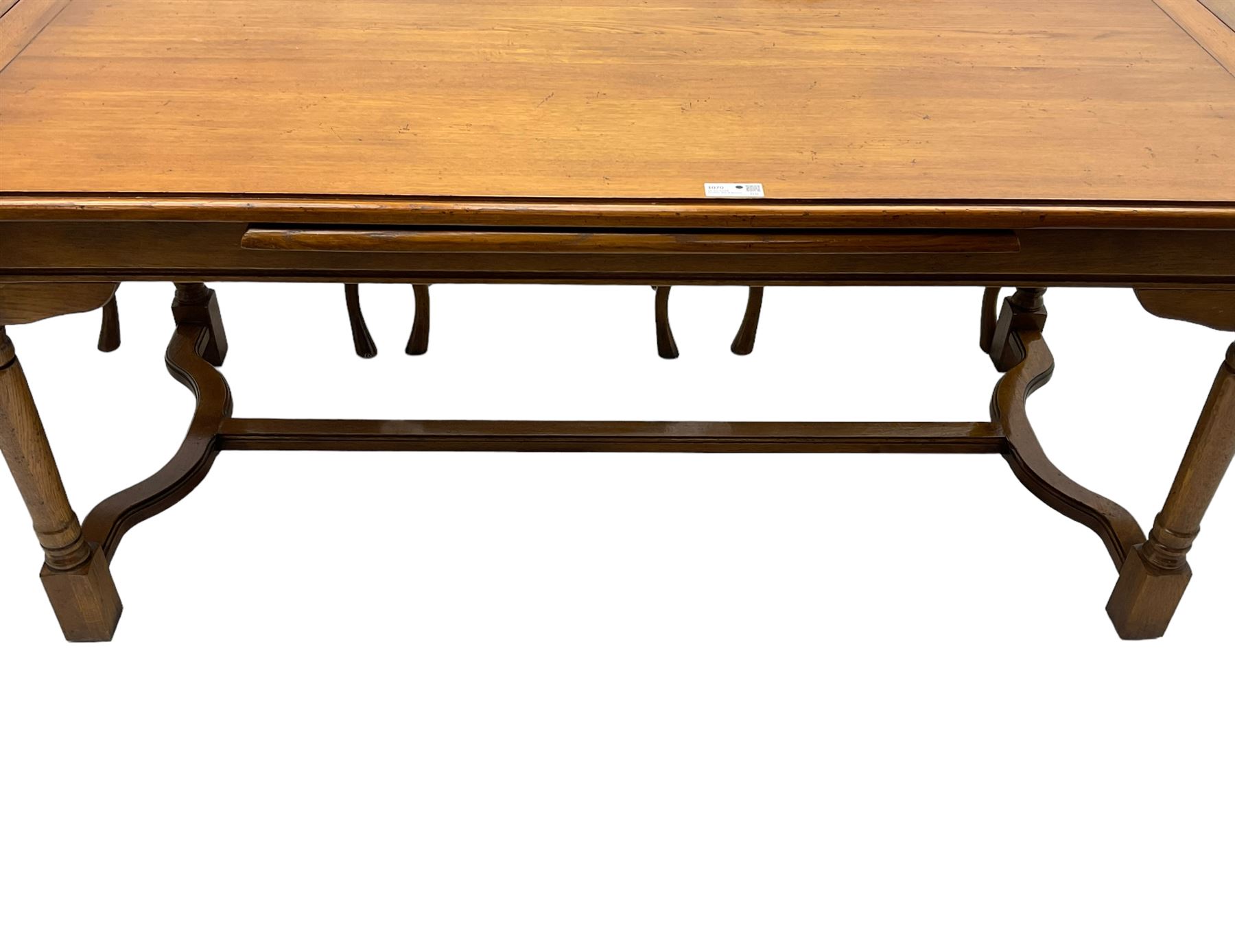 Late 20th century oak dining table, rectangular top with two draw leaf extensions, on turned supports united by moulded hayrake stretchers (180cm - 278cm x 90cm, H76cm); set of eight (6+2) oak dining chairs, shaped cresting rail over shaped splat back, upholster drop-in seat, on cabriole supports united by turned H-shaped stretchers 