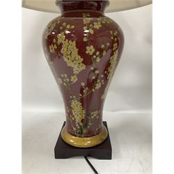 Pair of large table lamps of tapering form, decorated with Japanese blossom on a red ground, upon a square base, including shade H72cm