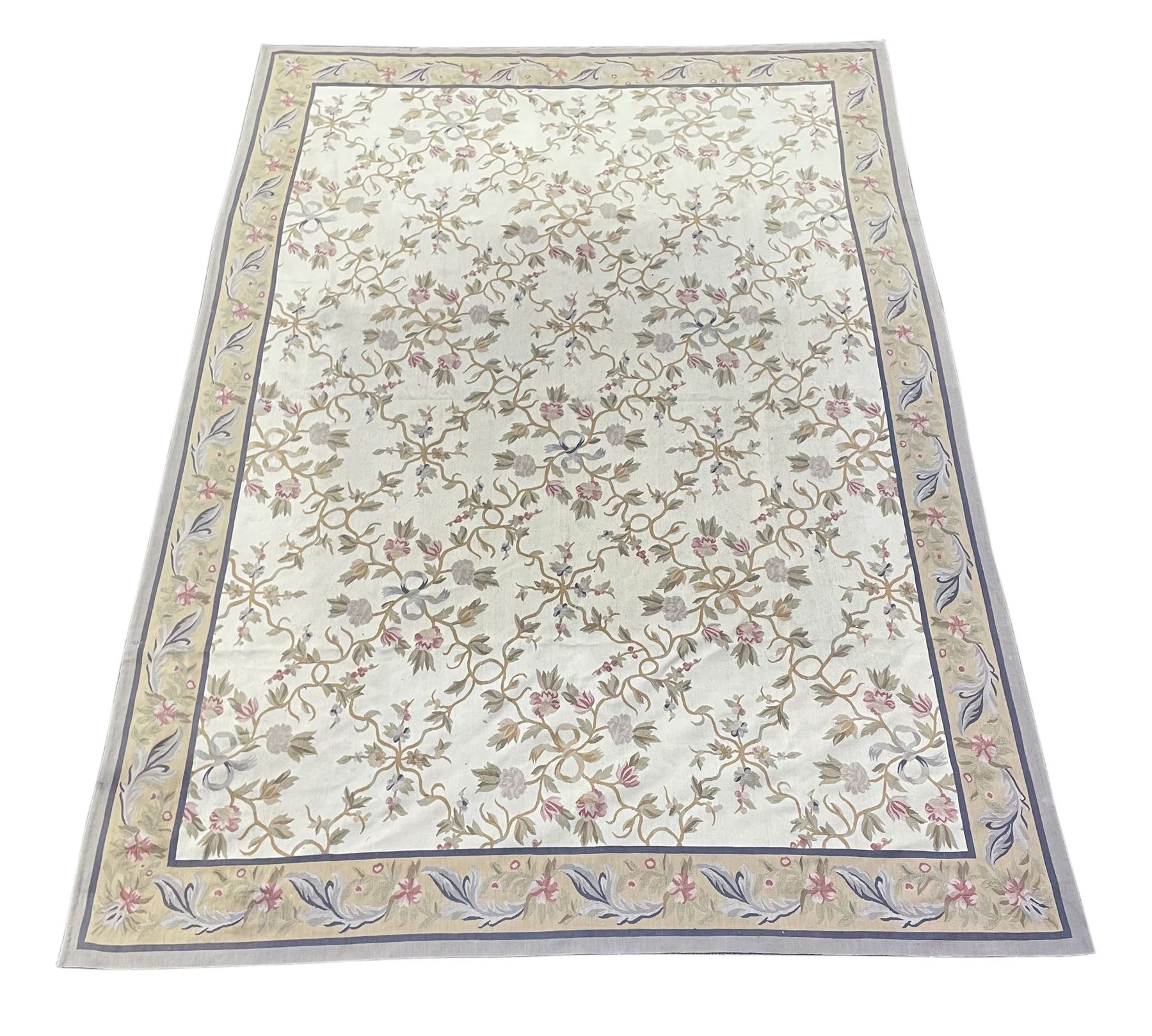 French style Aubusson rug, the pale ground field decorated with interlacing foliage and flower heads, repeating border 