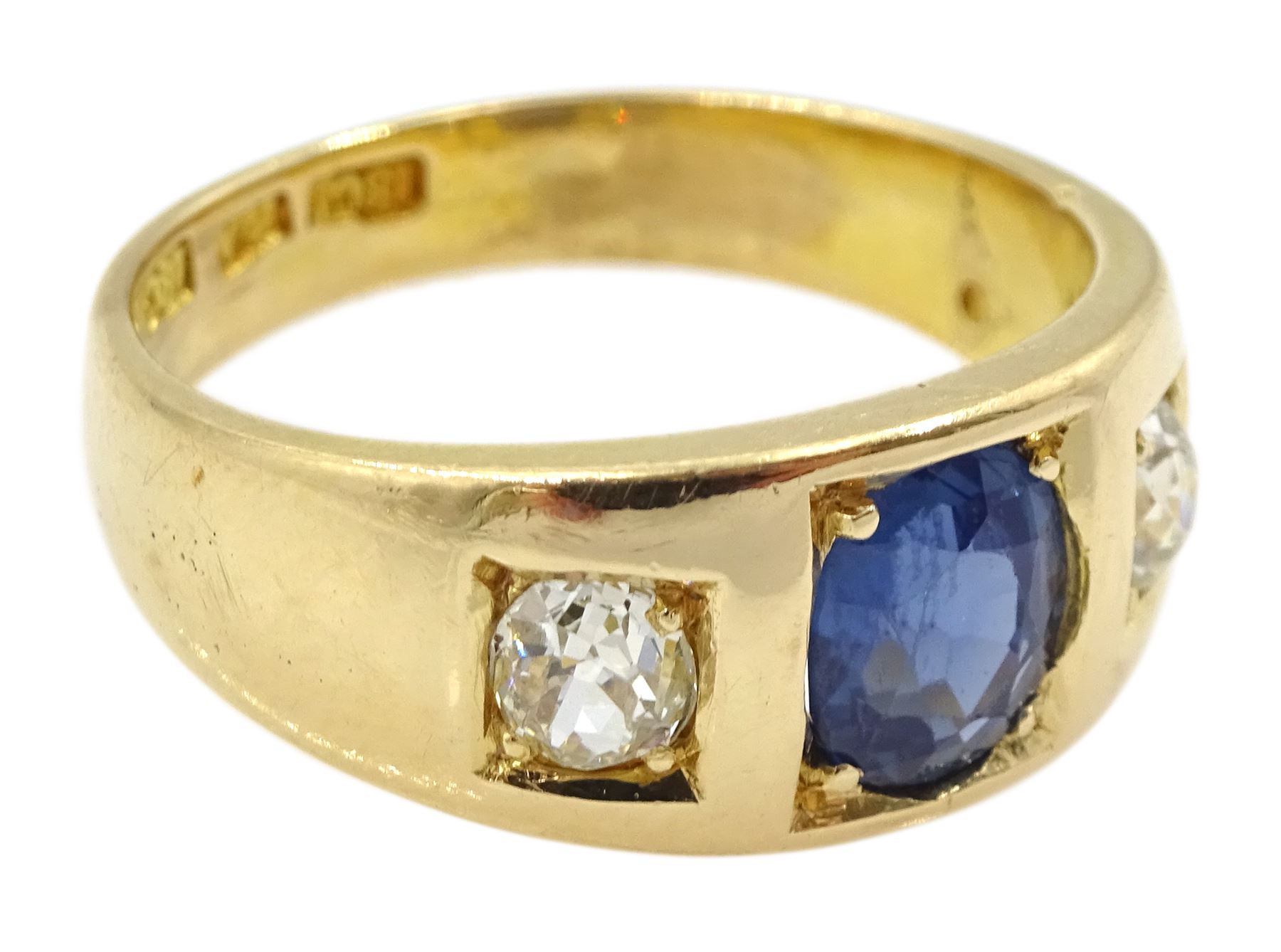 Late 19th century continental gypsy set three stone oval sapphire and old cut diamond ring, stamped 18ct, makers mark HA, total diamond weight approx 0.45 carat, sapphire approx 1.05 carat