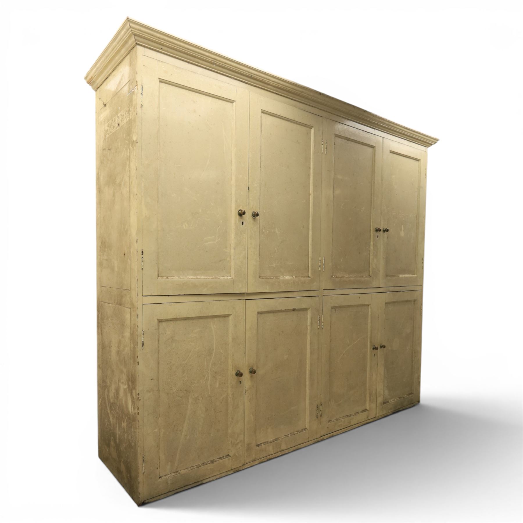 Large Georgian painted pine housekeepers cupboard, projecting cornice with four sets of twin cupboard doors with shelving enclosed