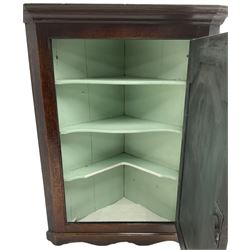 George III oak wall hanging corner cupboard, projected cornice over crossbanded and fielded panelled door, enclosing three shelves