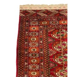 Persian Bokhara rug, red ground and decorated with repeating Gul motifs