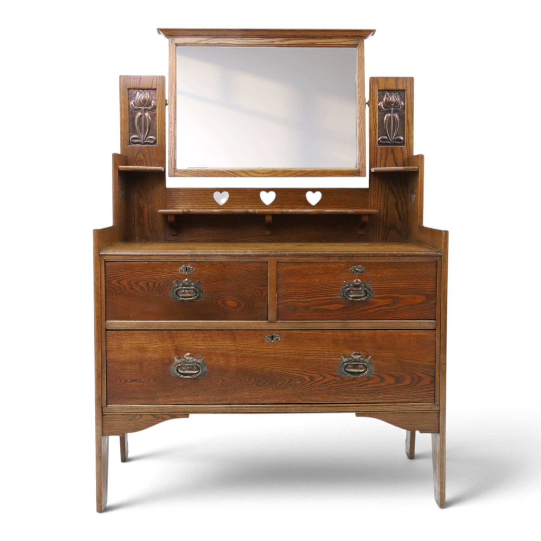 Shapland & Petter - oak mirrored dressing chest, tilted mirror flanked by tulip carved supports, shaped shelves with heart cut outs, above two short over one long drawers, with brass handles and stamped S & P on the locks, raised on shaped supports