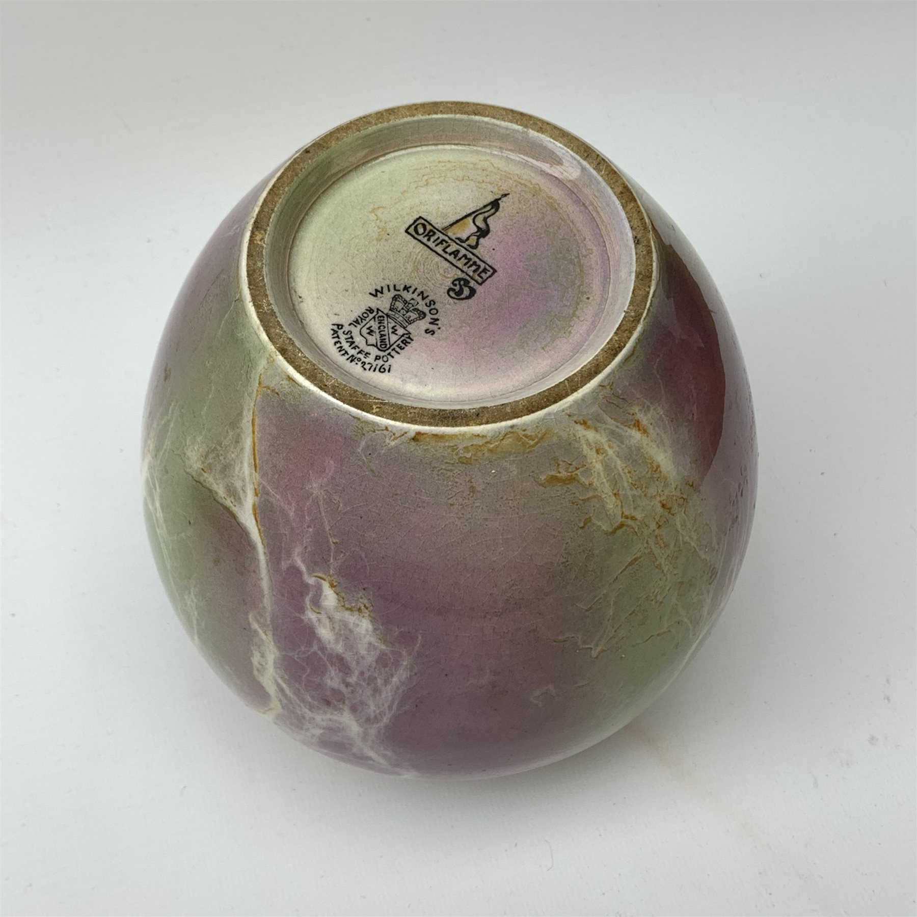 An A J Wilkinson Oriflamme vase designed by John Butler, of ovoid form with lustre marbled decoration, with marks beneath and artists monogram for John Butler, H15cm. 