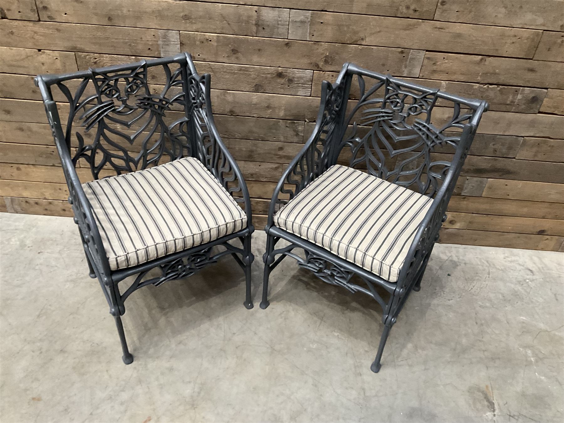 Richard Bawden (1936-2024): Pair of Cat design painted cast iron garden armchairs
