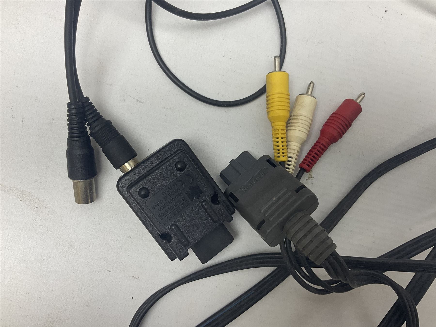 Nintendo 64 console, two controllers, games and accessories. Accessories to include the ‘Tremorpak’ and ‘Spook’ 2 Phono plugs and a S-VHS plug with adapter, both in original boxes. Games to include ‘Golden Eye 007’, ‘Doom 64’, ‘Killer Instinct Gold’, ‘Tetrisphere’, ‘F-1 World Grand Prix’, ‘Pilotwings 64’ and ‘Lylatwars’ with ‘Rumble Pak’, all with original boxes and instruction manuals. ‘Star Wars Episode I Racer’ game cartridge in Shadows of the Empire box. 