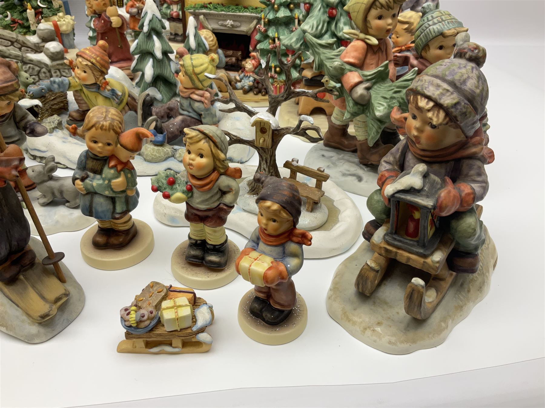 Large collection of Christmas themed Hummel figures and Hummel scapes by Goebel, to include Winter Friend, Making New Friends, Tree Trimming Time, Winter Adventure etc